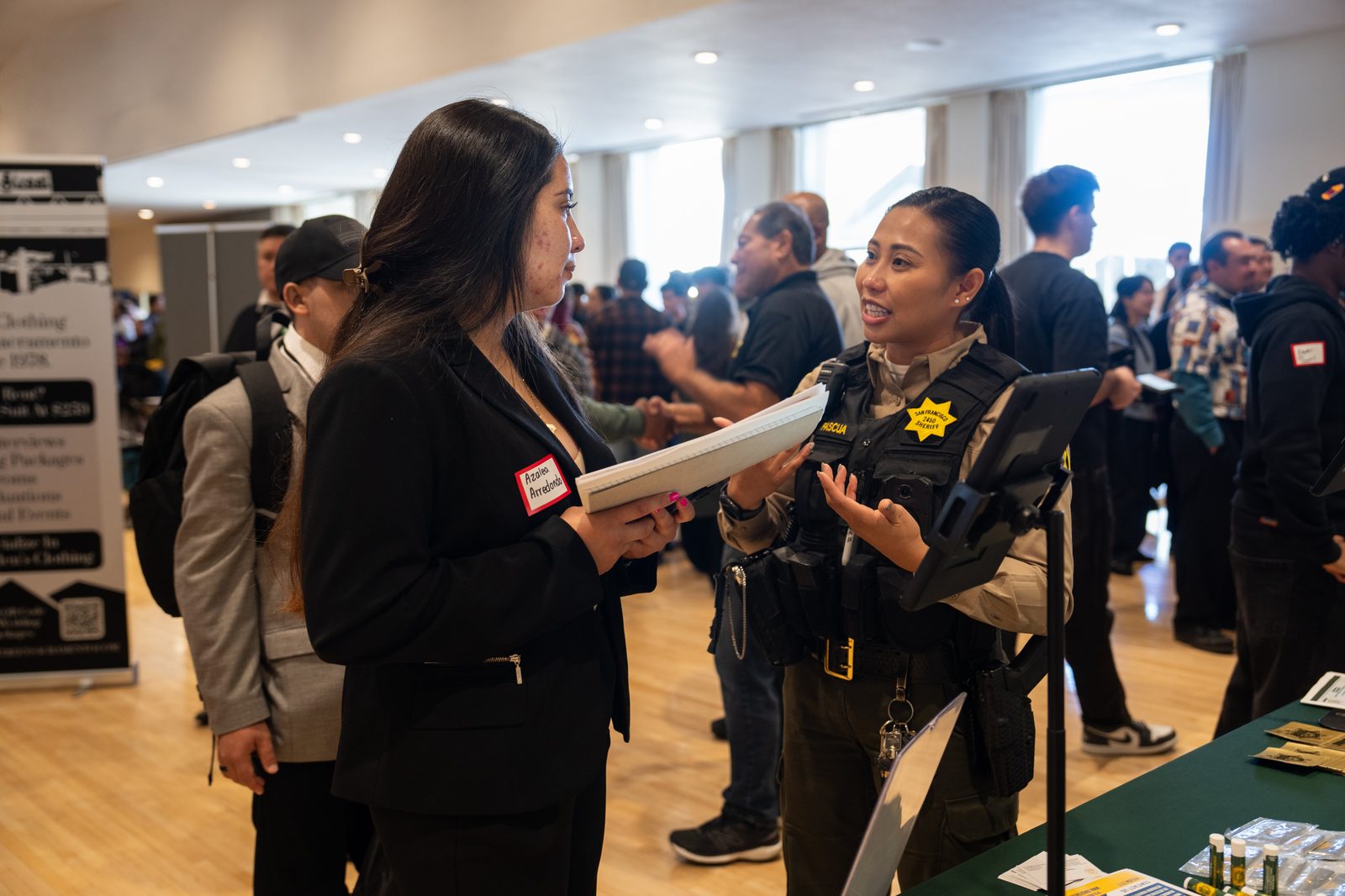 San Francisco Sheriff officer speaking with a candidate at SacJobs Career Fair